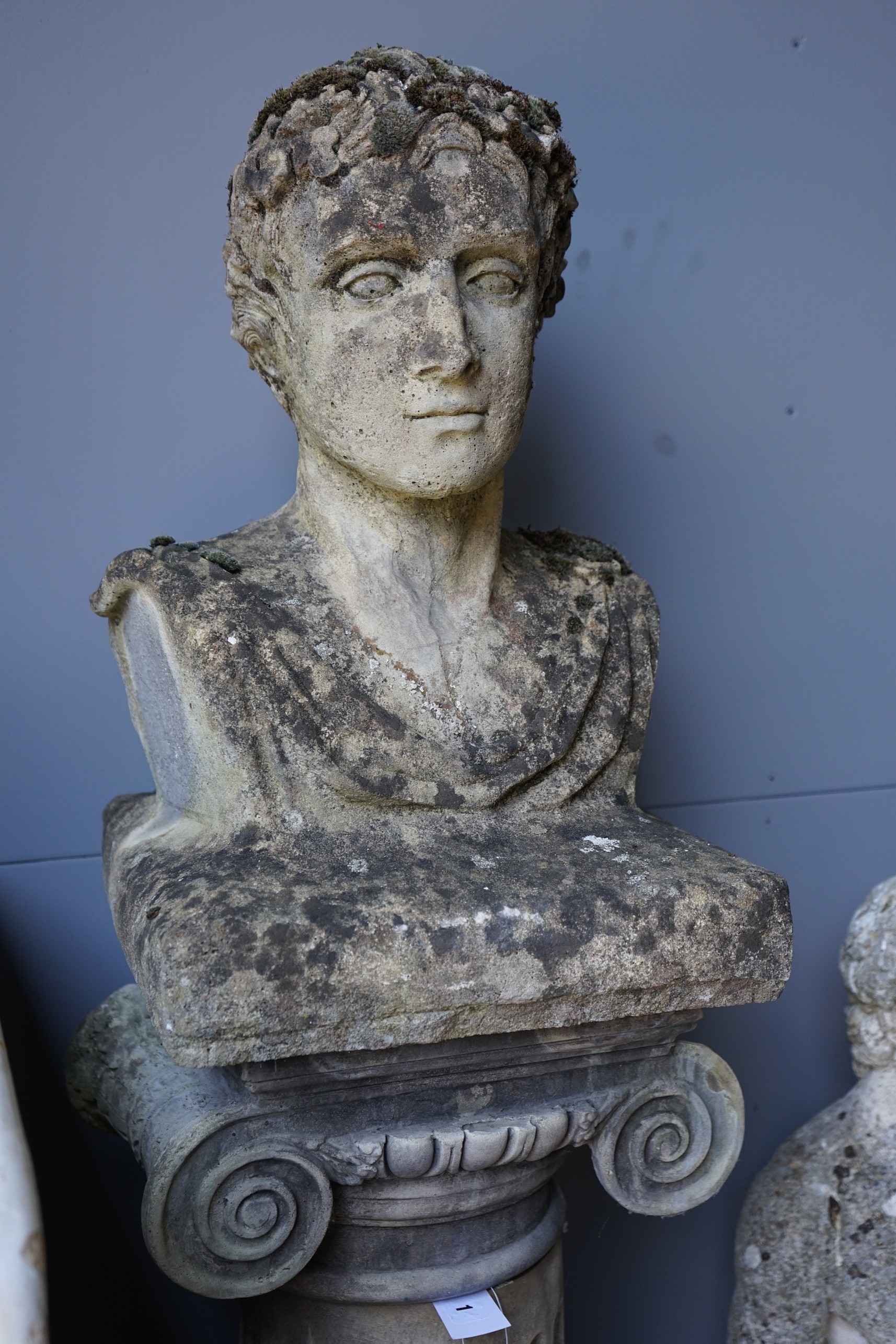 A reconstituted stone bust of a Roman emperor on fluted ionic column, height 172cm